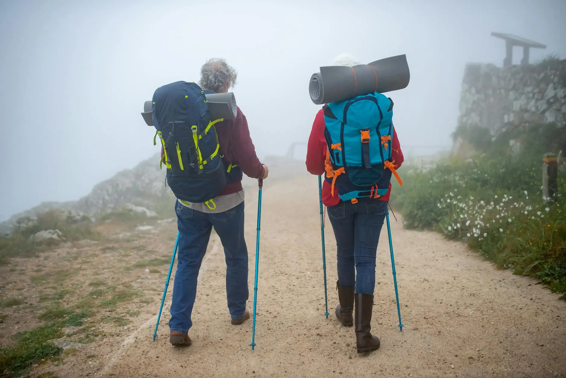 a couple walking on dirt road