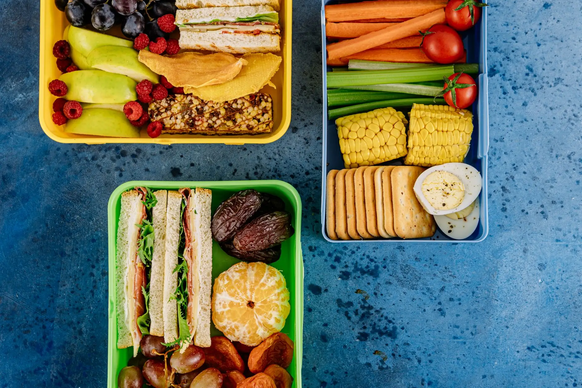 healthy lunch boxes on the blue surface