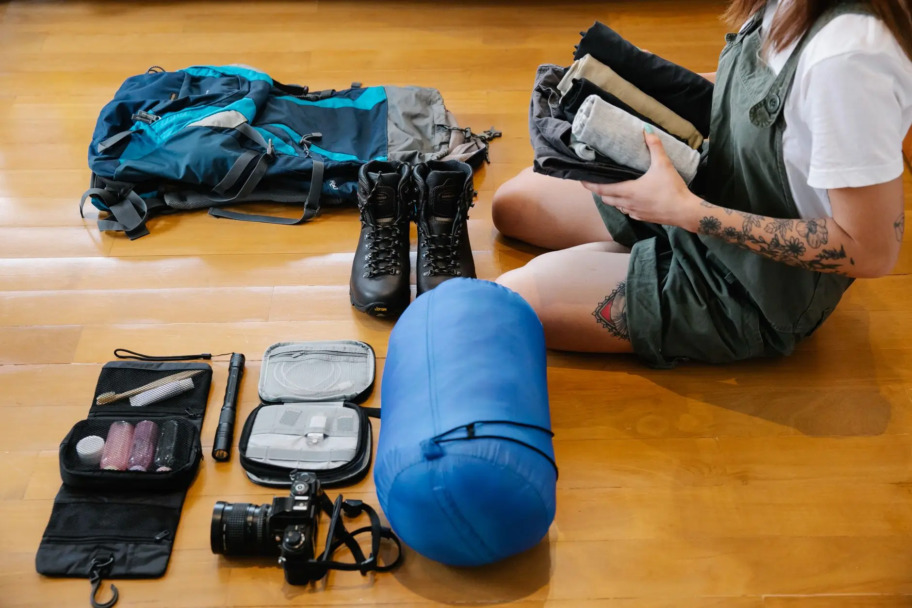 woman sitting on floor while packing up