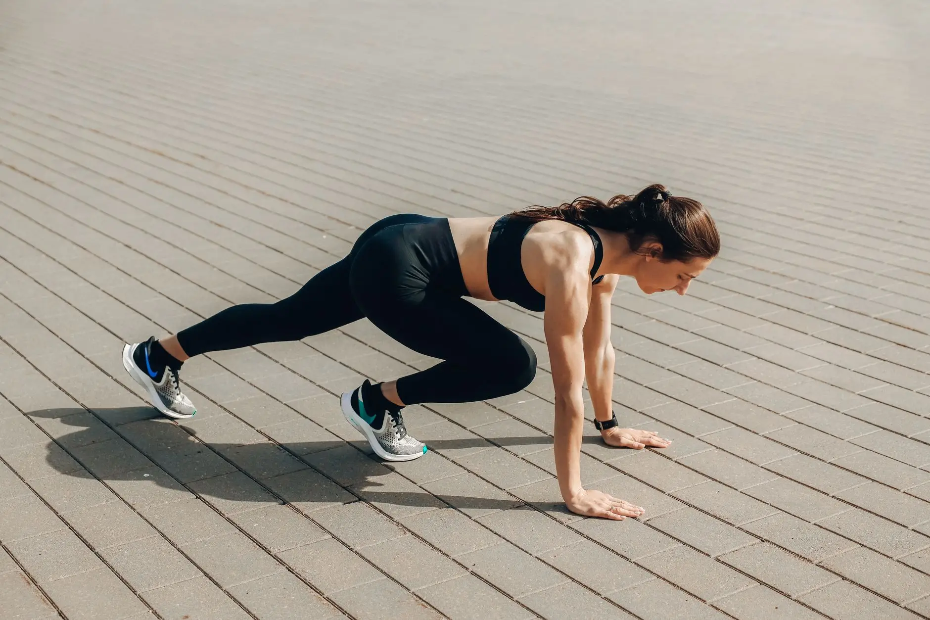 woman in black tank top and black leggings doing yoga